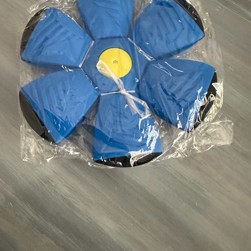 *New in package* Pet toy, flying saucer ball.  Rolls, pops and lights up.